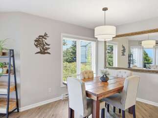 This dining room features a rustic wooden table surrounded by upholstered chairs, perfect for family meals.