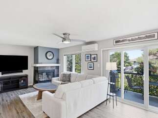 Experience modern living in this spacious living room featuring a sleek fireplace and a comfortable sectional sofa.