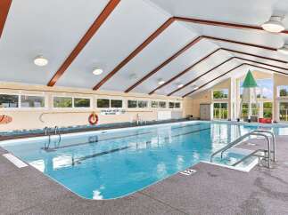 Dive into relaxation in this indoor swimming pool, featuring crystal-clear blue water and ample space for laps or leisure.