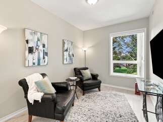 Relax and unwind in this cozy reading nook, featuring two plush leather armchairs perfect for quiet contemplation.