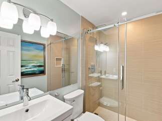 Experience modern luxury in this stunning bathroom featuring a sleek vanity with a vessel sink and chrome fixtures.
