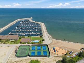 Experience waterfront living with this stunning property featuring a private marina with numerous boat slips, perfect for sailing enthusiasts.