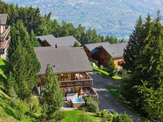 Experience luxury mountain living in this stunning chalet, nestled amidst lush greenery with breathtaking valley views.