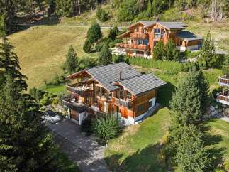 Experience luxury mountain living in this stunning wooden chalet, nestled on a picturesque hillside with breathtaking views.