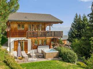 Experience luxury mountain living in this stunning wooden chalet, complete with a private hot tub and expansive balcony offering breathtaking views.