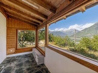 Experience breathtaking mountain views from this charming sunroom, featuring expansive windows that flood the space with natural light.