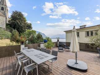 Enjoy breathtaking lake and mountain views from this stunning outdoor dining area.