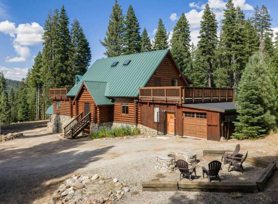 Experience rustic charm in this stunning log cabin nestled amidst towering pine trees.