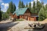 Experience rustic charm in this stunning log cabin nestled amidst towering pine trees.