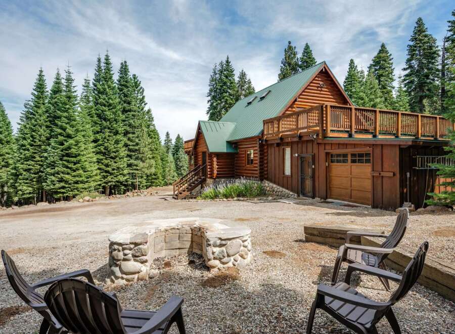 Escape to this stunning log cabin nestled amidst towering pine trees, offering a serene mountain retreat.