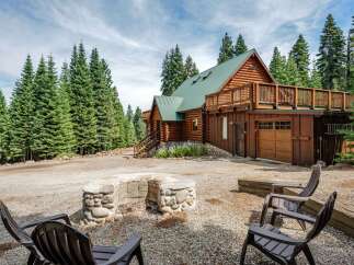 Escape to this stunning log cabin nestled amidst towering pine trees, offering a serene mountain retreat.