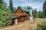 Experience rustic charm in this stunning log cabin nestled amidst towering pine trees.