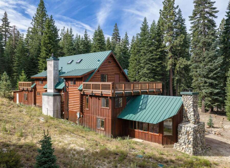 Nestled amidst towering pine trees, this rustic log cabin offers a serene mountain retreat.