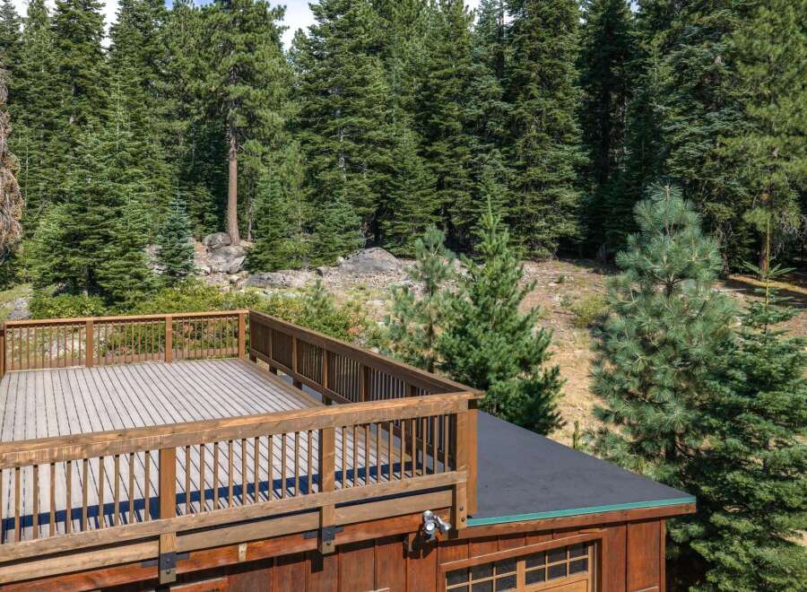 Enjoy the serene mountain views from this expansive wooden deck, perfect for outdoor entertaining or quiet relaxation.