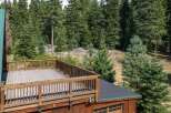 Enjoy the serene mountain views from this expansive wooden deck, perfect for outdoor entertaining or quiet relaxation.