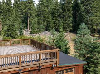 Enjoy the serene mountain views from this expansive wooden deck, perfect for outdoor entertaining or quiet relaxation.