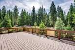 Step onto this expansive wooden deck, perfect for outdoor entertaining and enjoying the serene forest views.