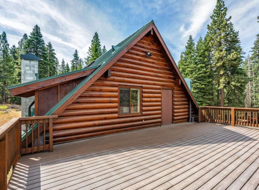 Experience rustic charm in this stunning log cabin, nestled amidst towering pine trees.