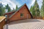 Experience rustic charm in this stunning log cabin, nestled amidst towering pine trees.