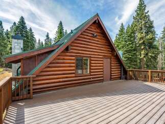 Experience rustic charm in this stunning log cabin, nestled amidst towering pine trees.