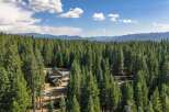 Nestled amidst a dense forest of towering pine trees, this charming cabin offers a serene retreat.