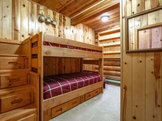 Discover cozy sleeping arrangements with this charming bunk bed set, perfect for cabins or kids' rooms.