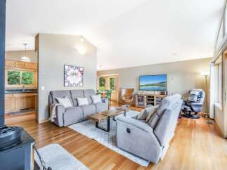 Step into this inviting living space featuring a cozy gray sofa and a comfortable recliner, perfect for relaxation.