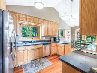 Discover this charming kitchen featuring warm oak cabinetry and sleek granite countertops.