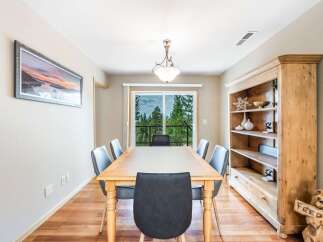 This dining room offers a spacious wooden table with comfortable seating, perfect for family gatherings.