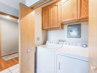 Discover convenience and functionality in this laundry space, featuring a stacked washer and dryer set.