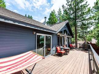Enjoy the outdoors on this spacious wooden deck, perfect for relaxation and entertaining.