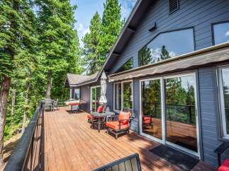 Enjoy the serene mountain views from this expansive wooden deck, perfect for outdoor entertaining or quiet relaxation.