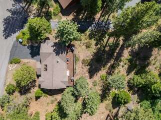 Experience serene living in this charming home, nestled amidst lush greenery and mature trees.