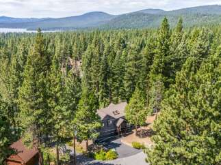 Nestled amidst a dense forest of towering pine trees, this charming home offers a serene retreat with stunning natural beauty.