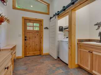 Discover the perfect blend of rustic charm and modern convenience in this entryway and laundry area.