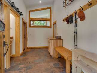 Step into this charming entryway featuring a rustic sliding barn door and warm wood accents throughout.