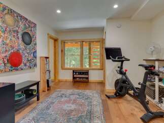 This home gym features a Peloton bike, perfect for your cardio workouts.