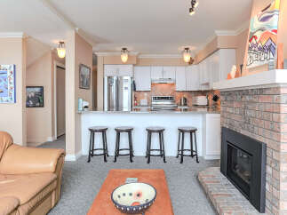 Experience comfortable living in this inviting space featuring a cozy living area with a plush leather sofa and a stylish brick fireplace.