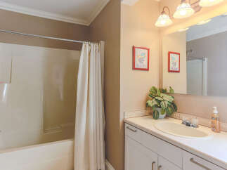 This charming bathroom features a pristine white bathtub with a convenient shower curtain for privacy.