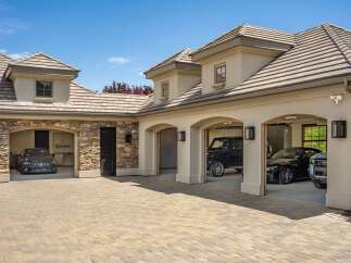 This luxurious estate boasts a spacious multi-car garage, perfect for car enthusiasts.