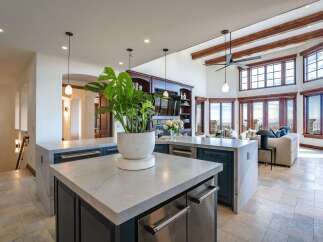 Experience luxury living in this stunning open-concept home, featuring a gourmet kitchen with expansive countertops and modern appliances.