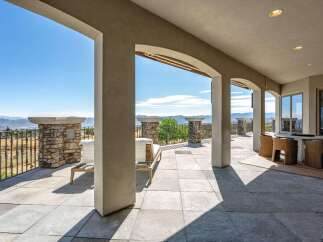 Experience breathtaking panoramic views from this expansive covered patio, perfect for entertaining or relaxing.