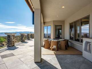 Enjoy breathtaking mountain views from this expansive covered patio, perfect for outdoor dining and entertaining.