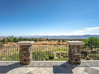 Experience breathtaking panoramic views from this stunning property, featuring a spacious patio perfect for entertaining or quiet relaxation.