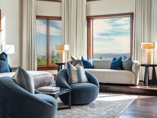 Experience breathtaking panoramic views from this luxurious living room, featuring expansive windows that frame the stunning natural landscape.