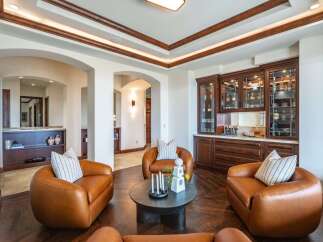 Experience luxury living in this sophisticated lounge area, featuring plush leather armchairs arranged around a modern coffee table.