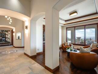 Step into this luxurious home, where elegant arches and warm wood floors create a welcoming ambiance.