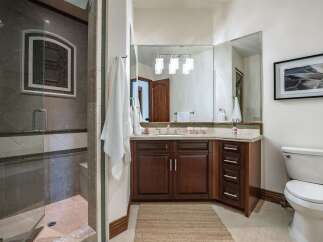 This luxurious bathroom features a spacious walk-in shower with elegant tile work and a glass door.