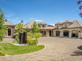 Discover this stunning luxury estate featuring a grand arched entryway and a multi-car garage.