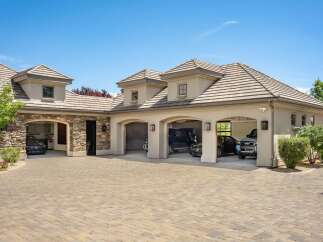 This luxurious estate boasts a spacious four-car garage, perfect for car enthusiasts or large families.
